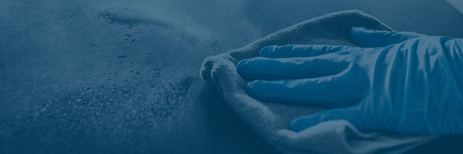 Glove-covered hand wiping surface